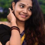 woman in black shirt smiling